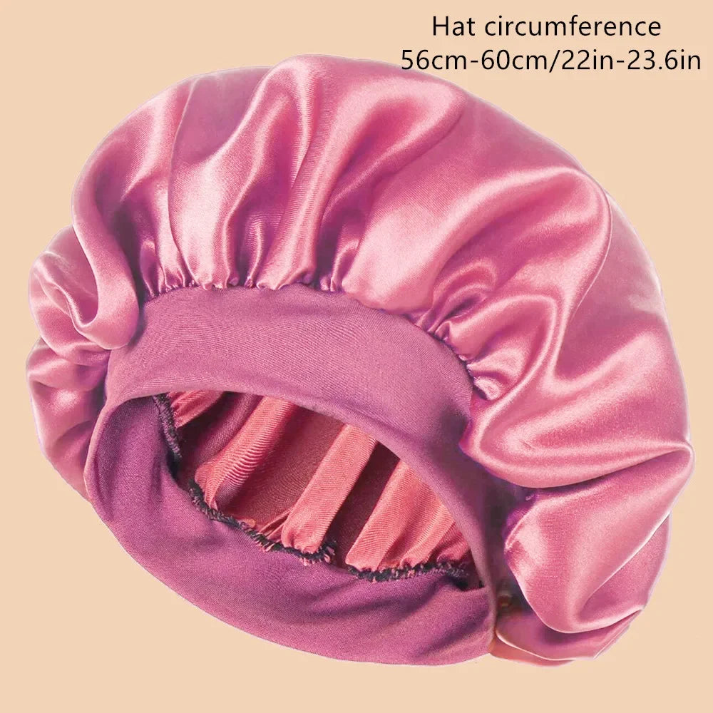 A pink satin wide brim shower cap shown from the side, highlighting its gathered texture.