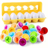 A yellow plastic tray holds multiple white and colored egg-shaped sorting puzzle toys for toddlers.