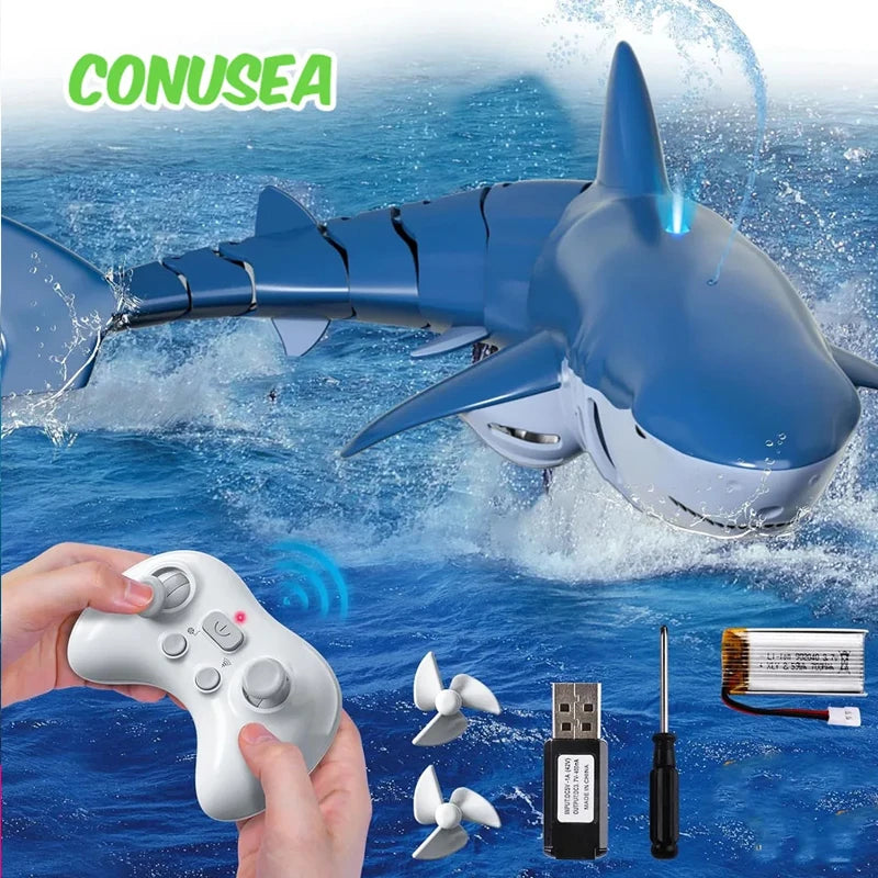 A remote control shark toy is shown spraying water in the ocean, with a hand holding the controller and other accessories.
