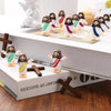A set of mini Jesus figurines dressed in white and purple for Easter décor and religious celebrations.