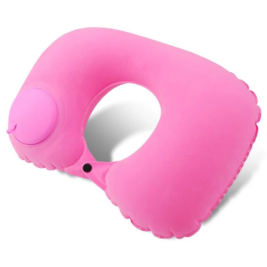 A bright pink self-inflating travel neck pillow with a soft flocking cover.