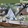 LED pillar candles in black lanterns displayed outdoors on a wooden surface with a timer function.