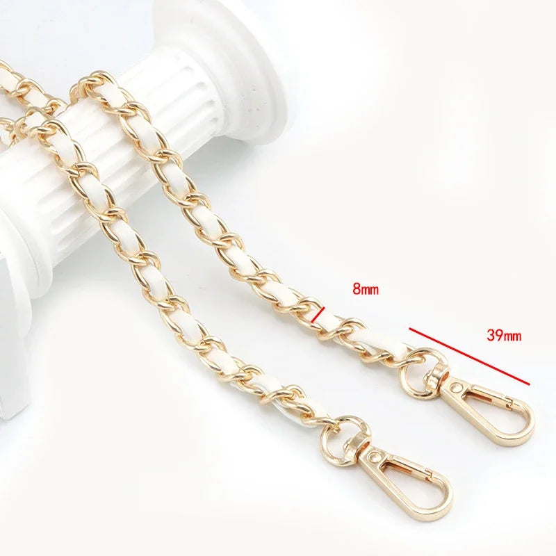Gold-colored universal chain strap for bags and phone cases shown next to a white object.