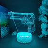 A glowing blue gun-shaped night light illuminates a textured surface against a dark background.