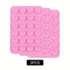 A pack of three pink reusable silicone suction phone mounts with circular suction cups.