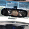 Rearview mirror covers with black fluffy trim installed on a vehicle interior.