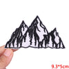 Black and white embroidered patch design of jagged mountain peaks on a white fabric background