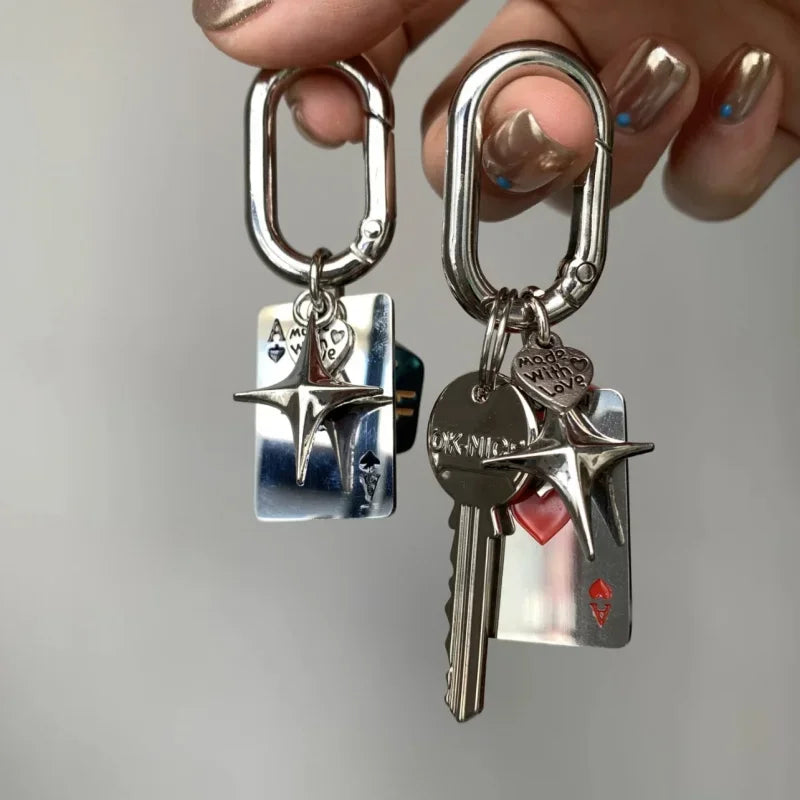 Silver keychain featuring a red dice heart charm and D-shaped buckle