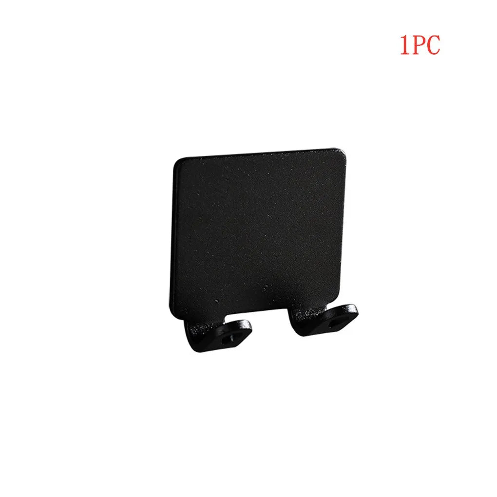 Black aluminum wall-mounted adhesive razor holder.