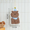 A fluffy brown cartoon bear hanging accessory with a yellow star on a white background.
