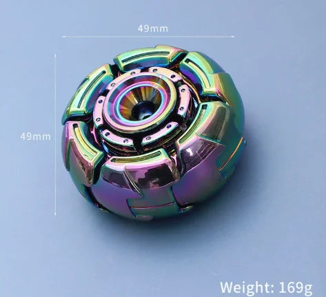 A close-up view of a metallic fidget spinner with iridescent purple and green accents, shown against a light blue background.