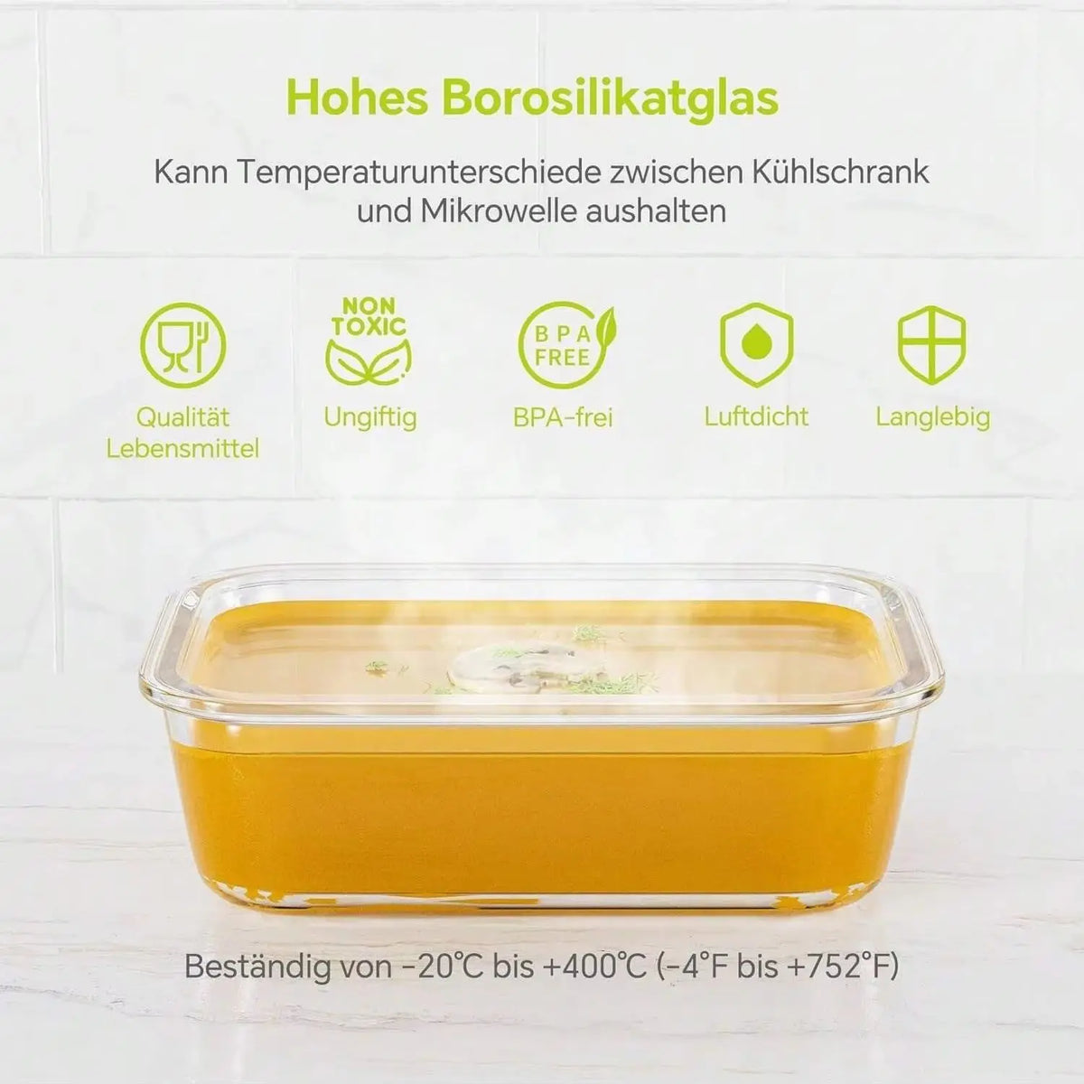 A clear glass food storage bowl filled with yellow-orange food, demonstrating temperature resistance.