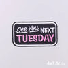 Black embroidered patch with pink text that reads See You Next Tuesday