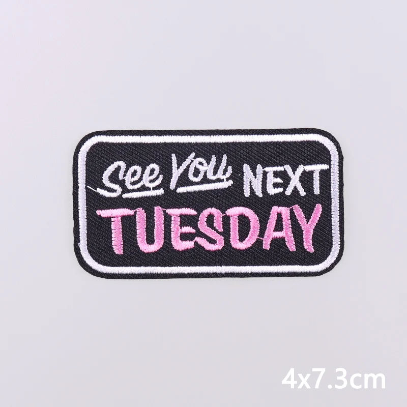 Black embroidered patch with pink text that reads See You Next Tuesday