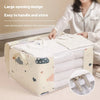 A person is handling a large opening storage bag for blankets and clothes, showing its easy access design.