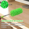 A bright green microfiber duster with an extendable handle is shown resting on a wooden surface.