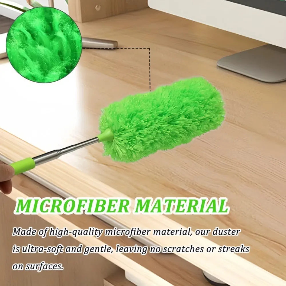 A bright green microfiber duster with an extendable handle is shown resting on a wooden surface.