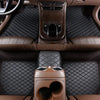 Interior view of a car with brown leather floor mats and a center console.