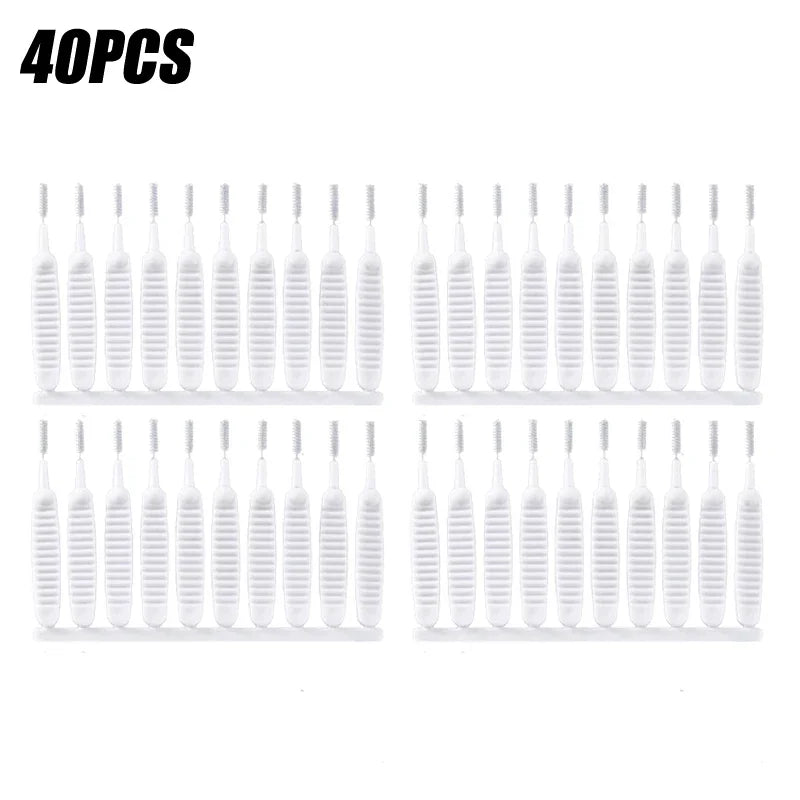 A set of 40 white shower cleaning brushes with nozzles for unclogging.