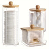 A clear glass and acrylic organizer set for cotton swabs, featuring wooden lids.