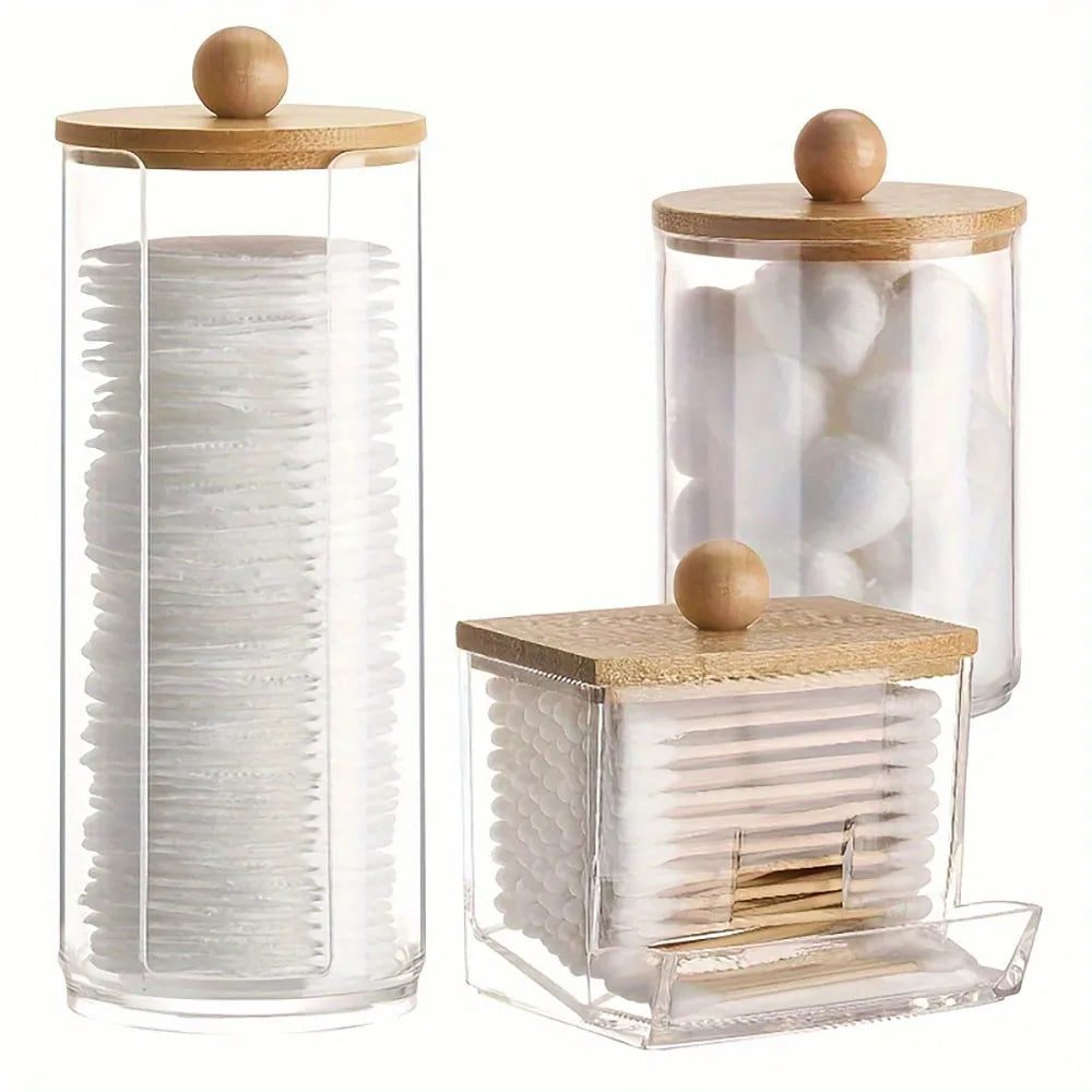 A clear glass and acrylic organizer set for cotton swabs, featuring wooden lids.