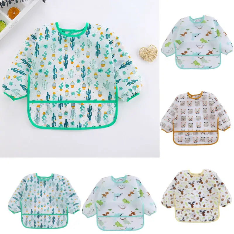 A collection of light green and white kids waterproof long sleeve smocks and feeding bibs featuring various nature-themed pat