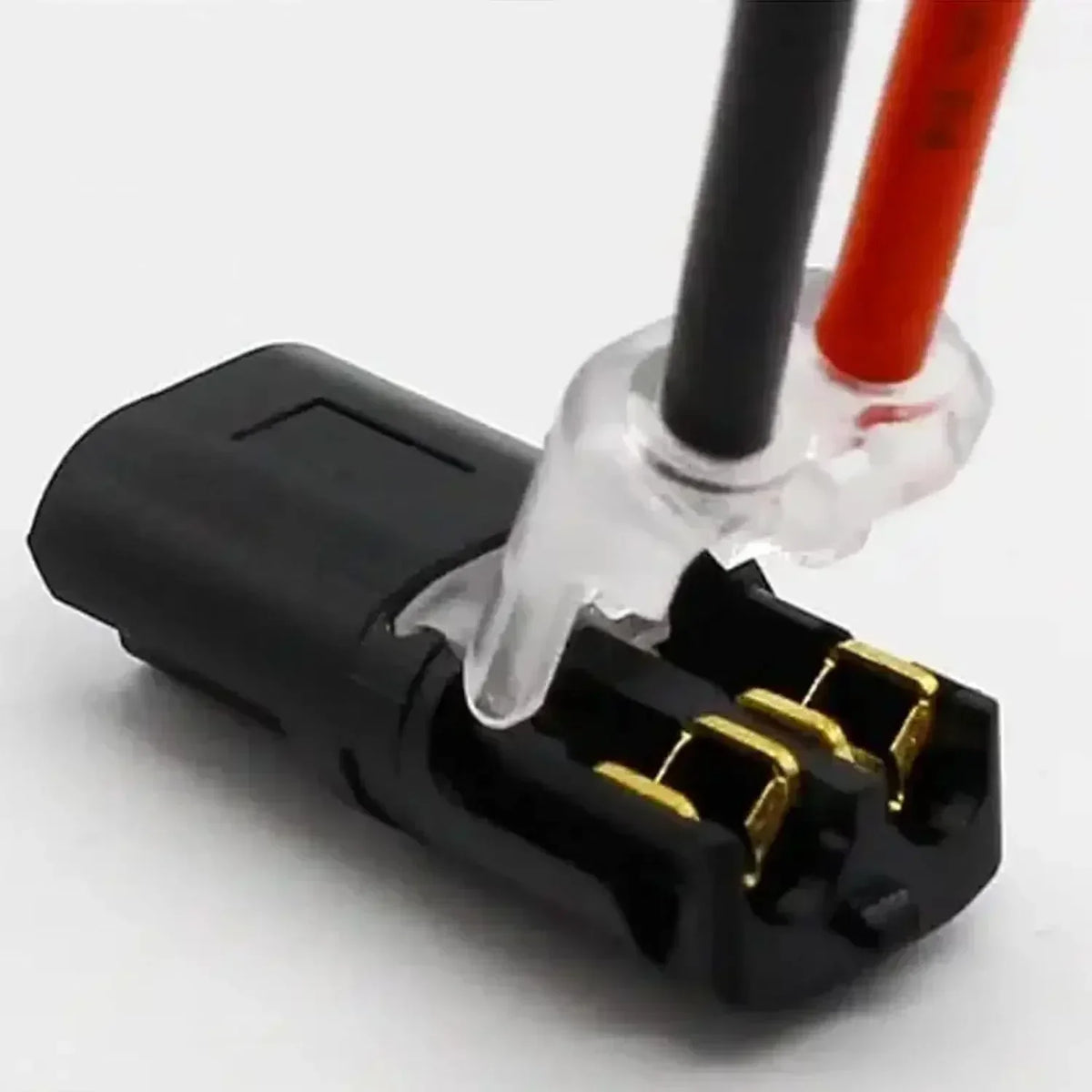 A close-up view of black and red quick splice wire connectors with clear insulation tips.