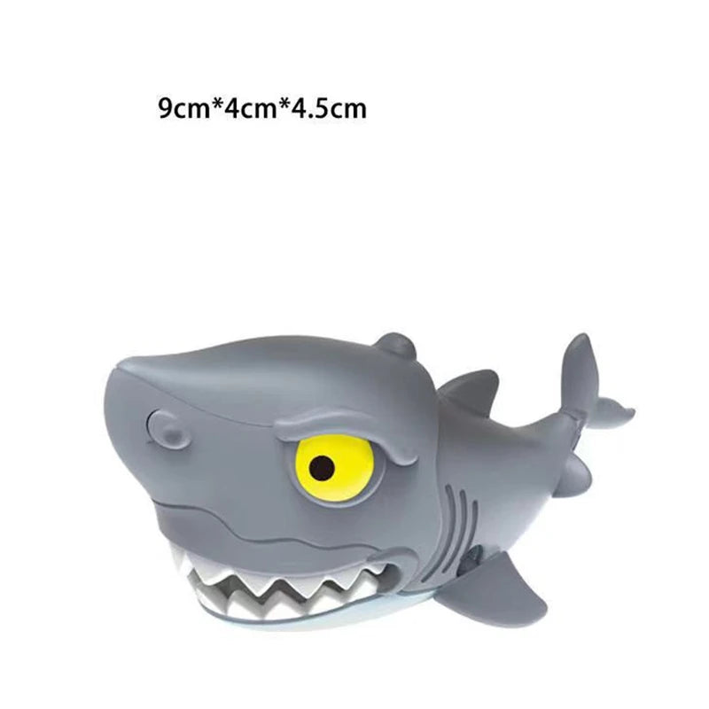 A gray plastic dinosaur toy resembling a Tyrannosaurus Rex with yellow eyes and visible teeth.