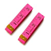 A pink fiberglass tape measure marked in inches and centimeters, showing a 60-inch scale.