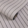 Roll of 3D grille pattern peel-and-stick wallpaper with black lines on a light background