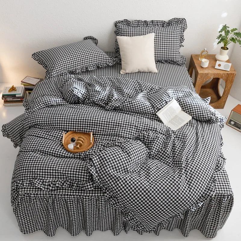 A black and white plaid duvet cover set with pillows displayed on a bed.