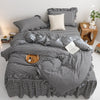 A black and white plaid duvet cover set with pillows displayed on a bed.