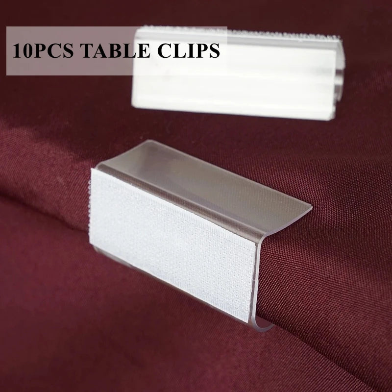 A set of 10 clear table clips and a silver ice silk table skirt are displayed on a dark red fabric.