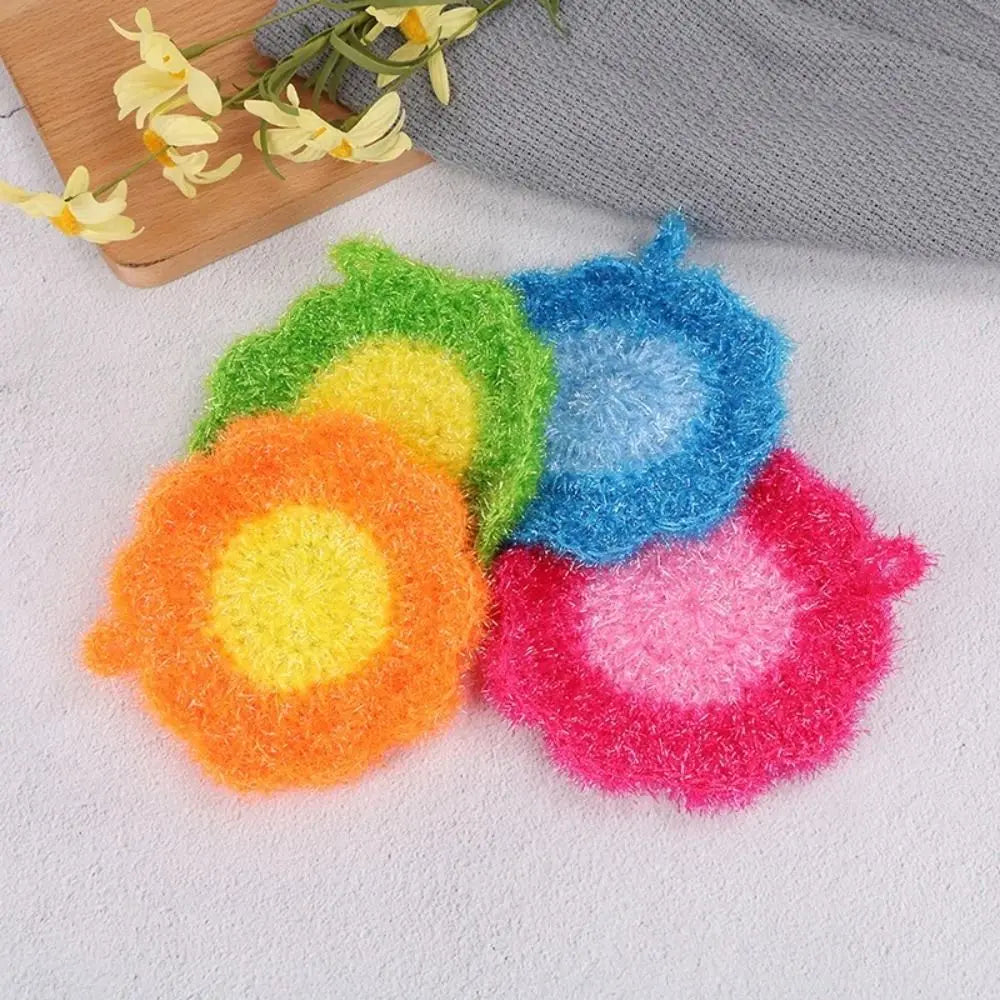 A collection of colorful acrylic non-stick dish sponges shaped like flowers in various shades of green, yellow, blue, and pin