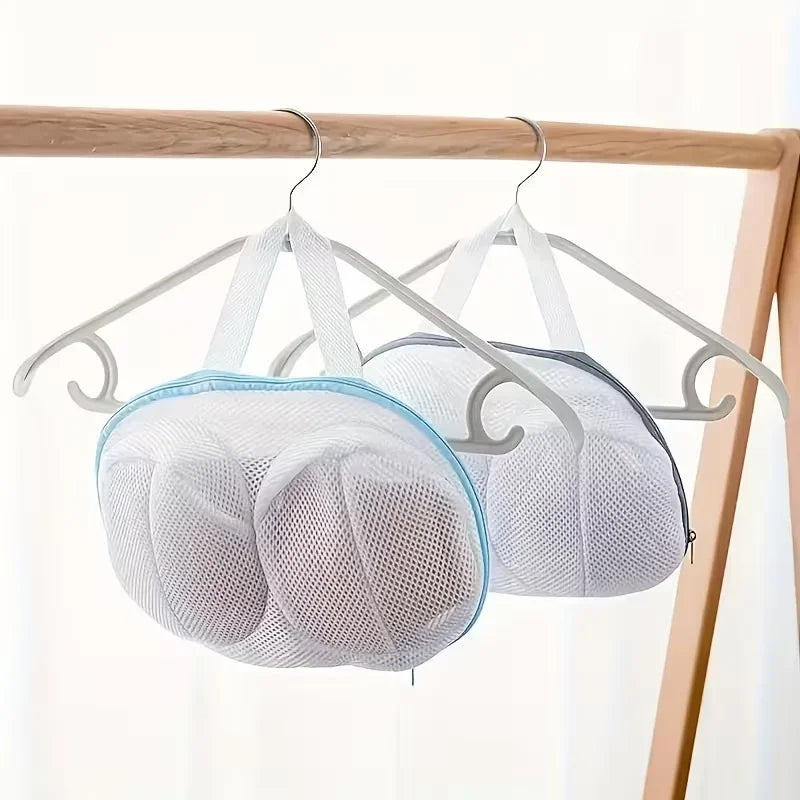 White mesh laundry bag for bras and lingerie hanging on a wooden rack.