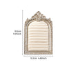 A rectangular jewelry display stand with an arched, ornate frame and a beige fabric insert.