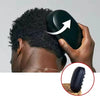 A hand is using a black afro twist hair brush and sponge comb kit on a person's head.