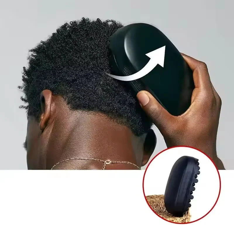 A hand is using a black afro twist hair brush and sponge comb kit on a person's head.