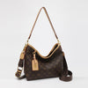 A brown leather tote bag with a gold chain strap and a dark brown monogram print.