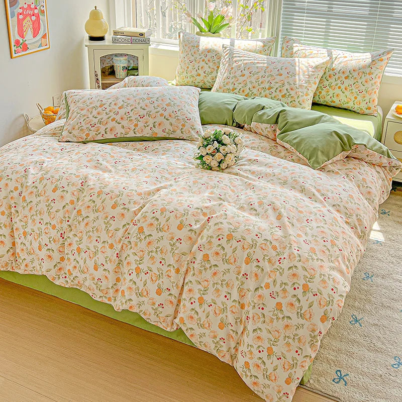 A floral duvet cover set featuring light pink and green patterns on a bed with matching pillows.