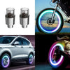 Motion-activated LED tire valve lights installed on a bicycle wheel and a car wheel.