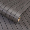 Roll of dark gray 3D grille pattern peel-and-stick wallpaper shown in a close-up view.