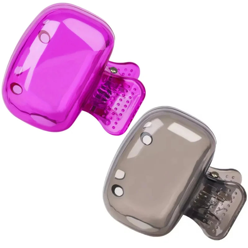 A pair of portable toothbrush head covers, one pink and one gray, shown side by side.