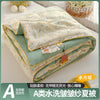 A washable quilt with a playful cartoon print in light green and cream colors.