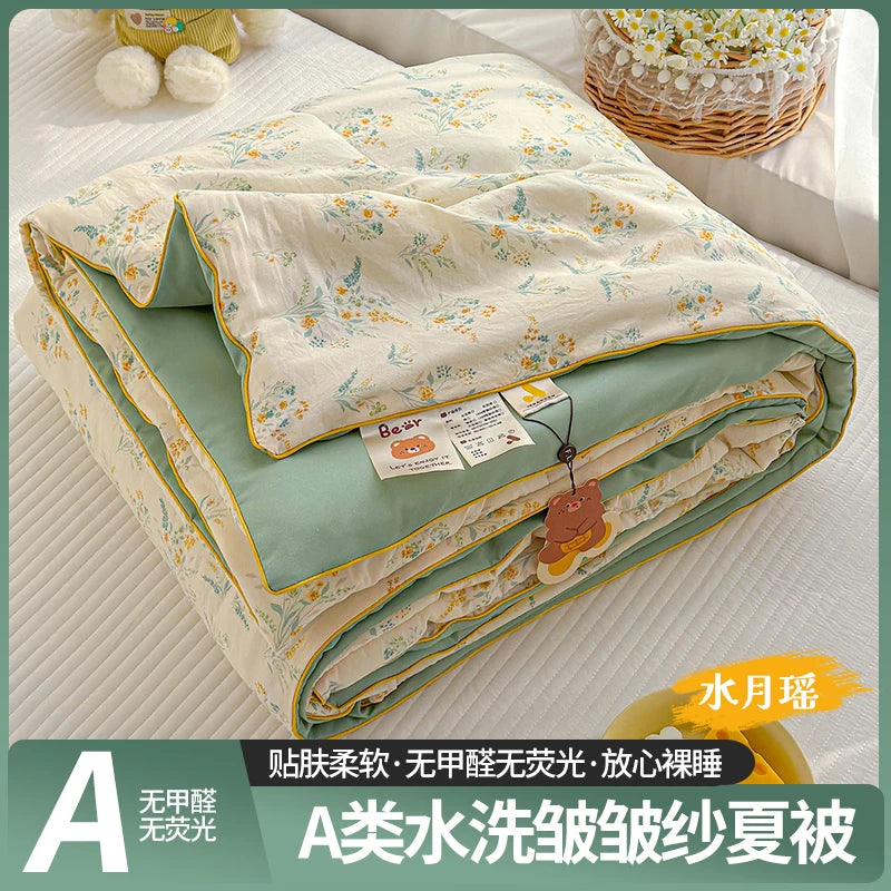 A washable quilt with a playful cartoon print in light green and cream colors.