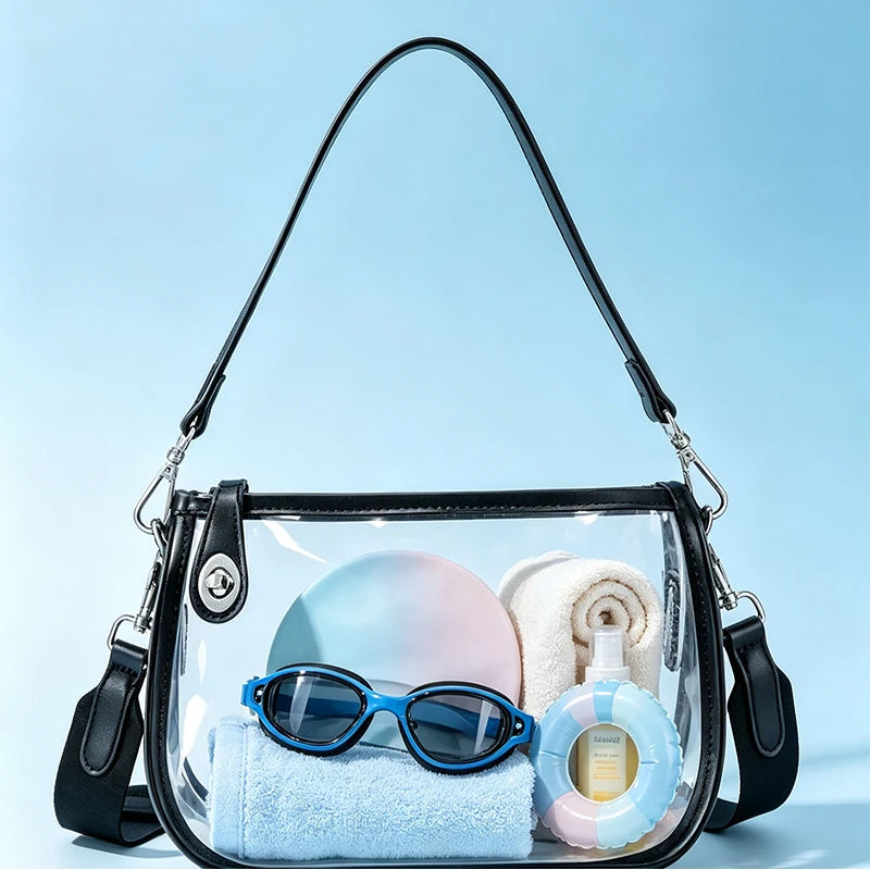 Clear PVC shoulder bag with an adjustable strap containing blue sunglasses and a white towel