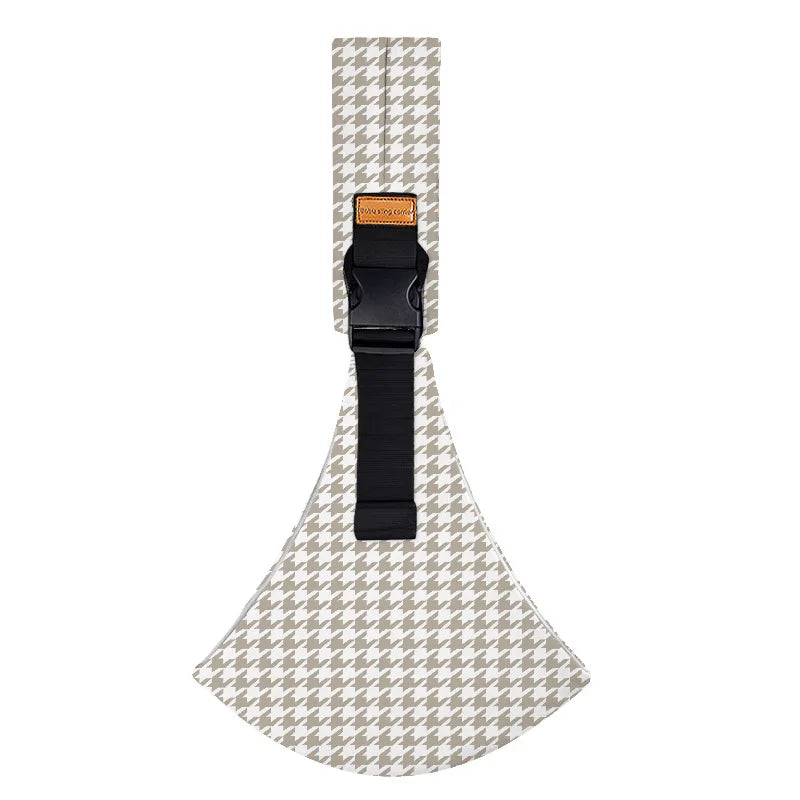 Ergonomic baby sling carrier with a patterned fabric and a black strap.