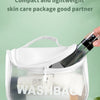 A clear plastic cosmetic pouch containing a refillable travel spray bottle and white cotton pads for skincare.