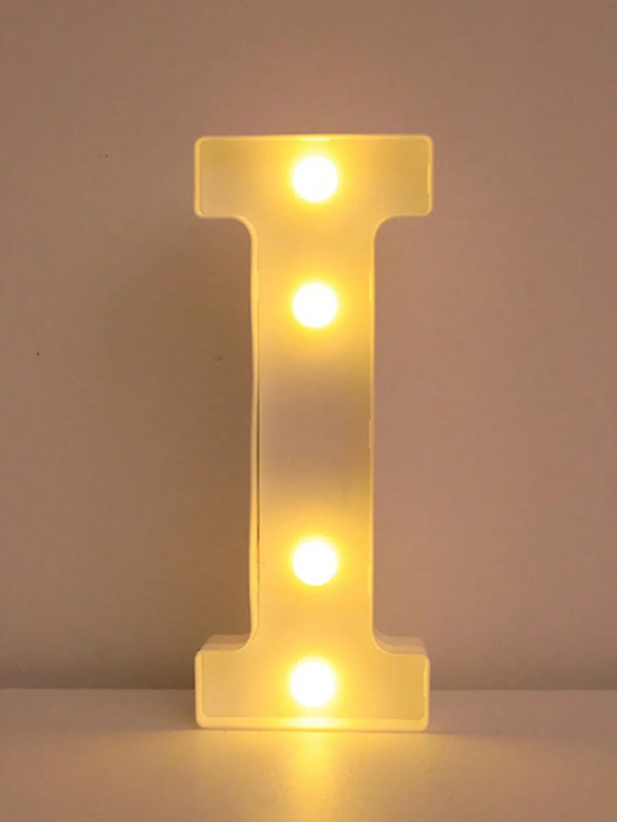 A glowing yellow LED letter I night light shaped like the letter I.