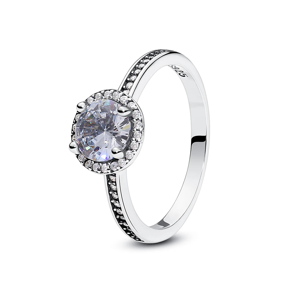 A sterling silver heart ring featuring a round cubic zirconia stone and pave-set detailing.